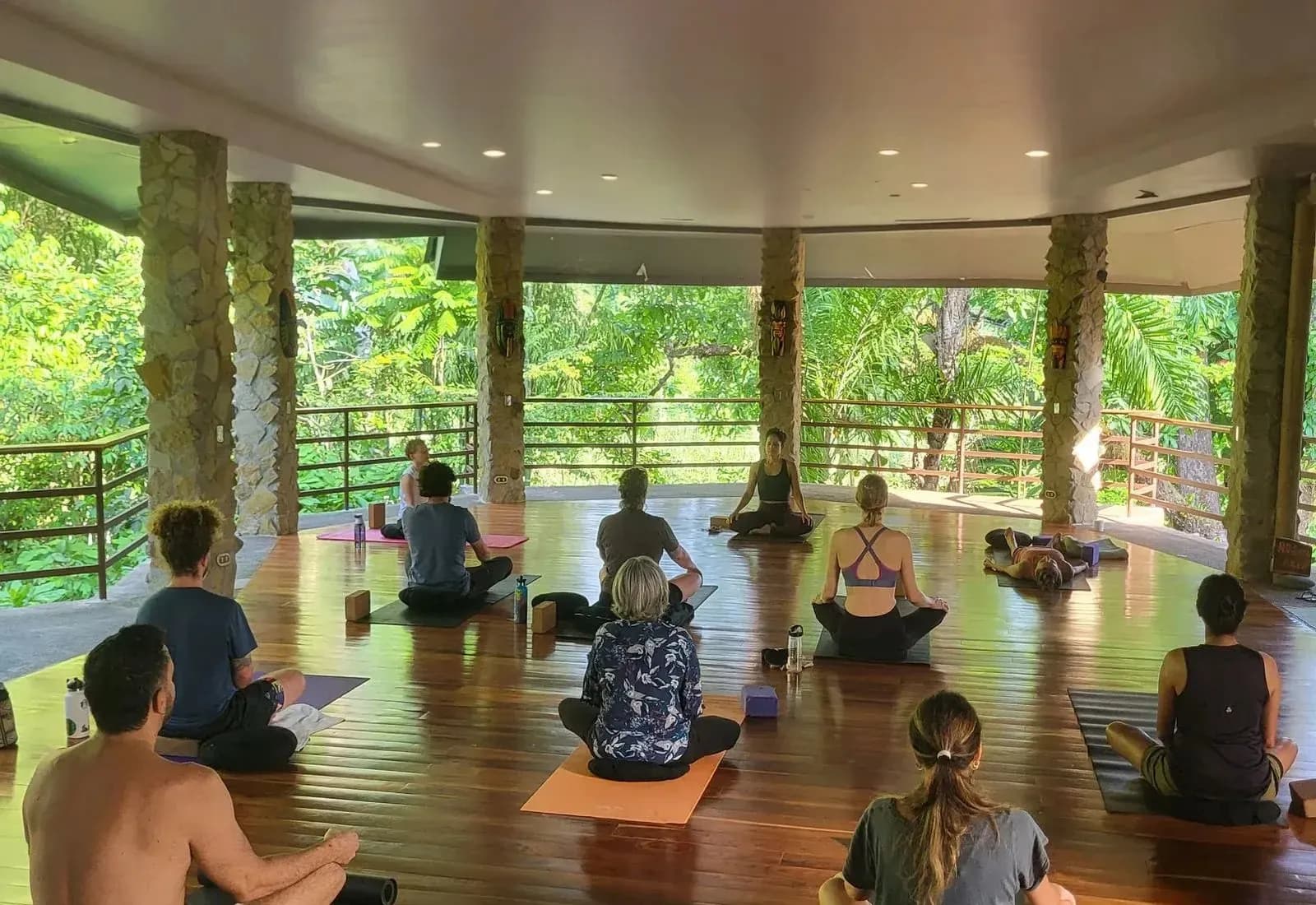 A morning yoga session on the open-air deck at Posada Natura, surrounded by forest